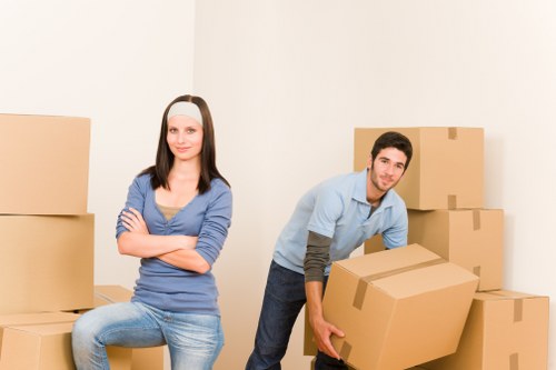 Worker wearing PPE while carrying furniture carefully
